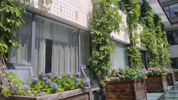 A building with vertical gardens and flower boxes along the exterior.