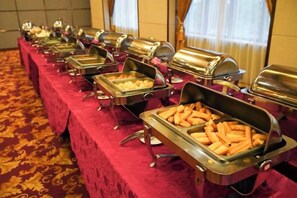A buffet setup with multiple food service stations. - Tangxi Hot Spring Resort (Chongren)