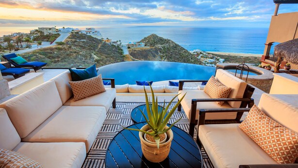 A terrace with a view of the sea, a pool, and outdoor seating. - Casa Vista Tranquila  (Cabo San Lucas)