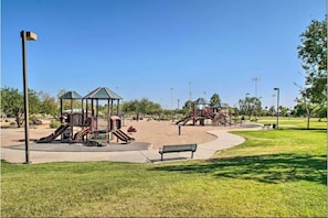 Enjoy a family-friendly atmosphere in this park with play structures, benches, and a beautifully manicured lawn.