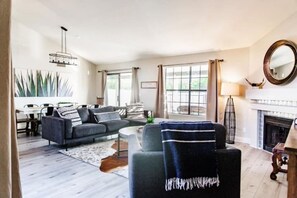 Cozy living room with a fireplace, sofa, and chair, offering a comfortable seating area.