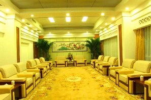 A conference room with a long table and multiple chairs, a patterned carpet, and a painting on the wall. - Jinshuiwan Holiday Resort (Shucheng)