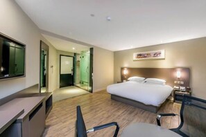 A hotel room with a bed, desk, chairs, a TV, and a painting on the wall. - Superior Hotel (Ziyuan Bus Station) (Ziyuan)