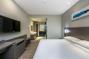 A modern hotel room with a large bed, a flat-screen TV mounted on the wall, a small desk, and a bathroom visible through an open door. - Superior Hotel (Ziyuan Bus Station) (Ziyuan)