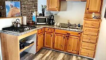 Fridge, microwave, coffee/tea maker, cookware/dishes/utensils