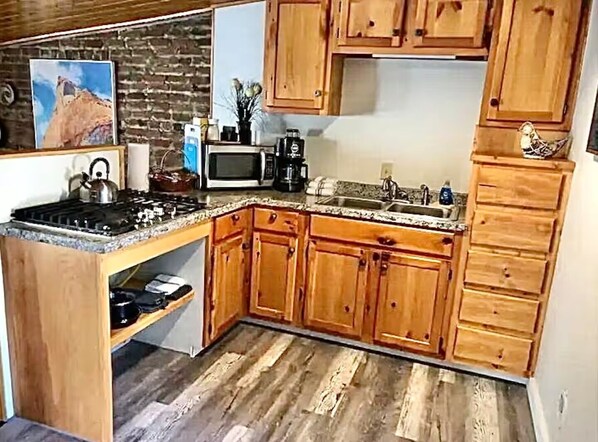 Fridge, microwave, coffee/tea maker, cookware/dishes/utensils