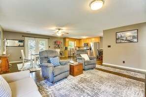 A living room with two gray armchairs, a white sofa, a wooden coffee table, and a patterned rug. - Browns Summit Vacation Rental w/ Fire Pit! (Browns Summit)