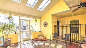 A sunlit patio with a stone fire pit, potted plants, and outdoor seating. - Venice Home w/ Private Pool, 7 Mi to Beach! (Venice)