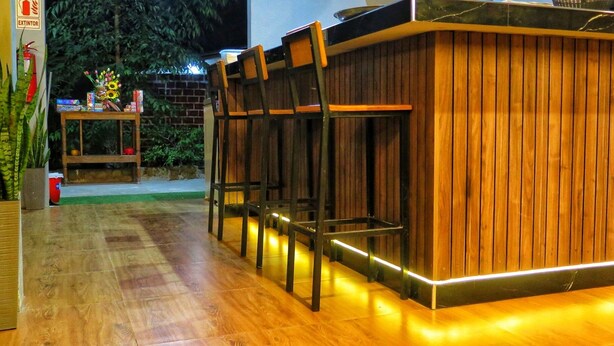 A wooden bar area with a counter and seating.