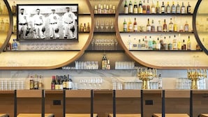 A bar with shelves of liquor bottles, glasses, and a vintage baseball photo. - Spacious House ~3min walk WrigleyField~Free Prkg (Chicago)