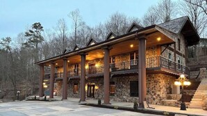 A large stone building with multiple balconies and a spacious entrance area.
