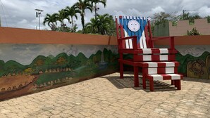 A mural with a boat and mountains, a red and white chair, and a sign that says "Los Angeles". - comfortable, fresh, 2 bedroom in the country (Utuado)