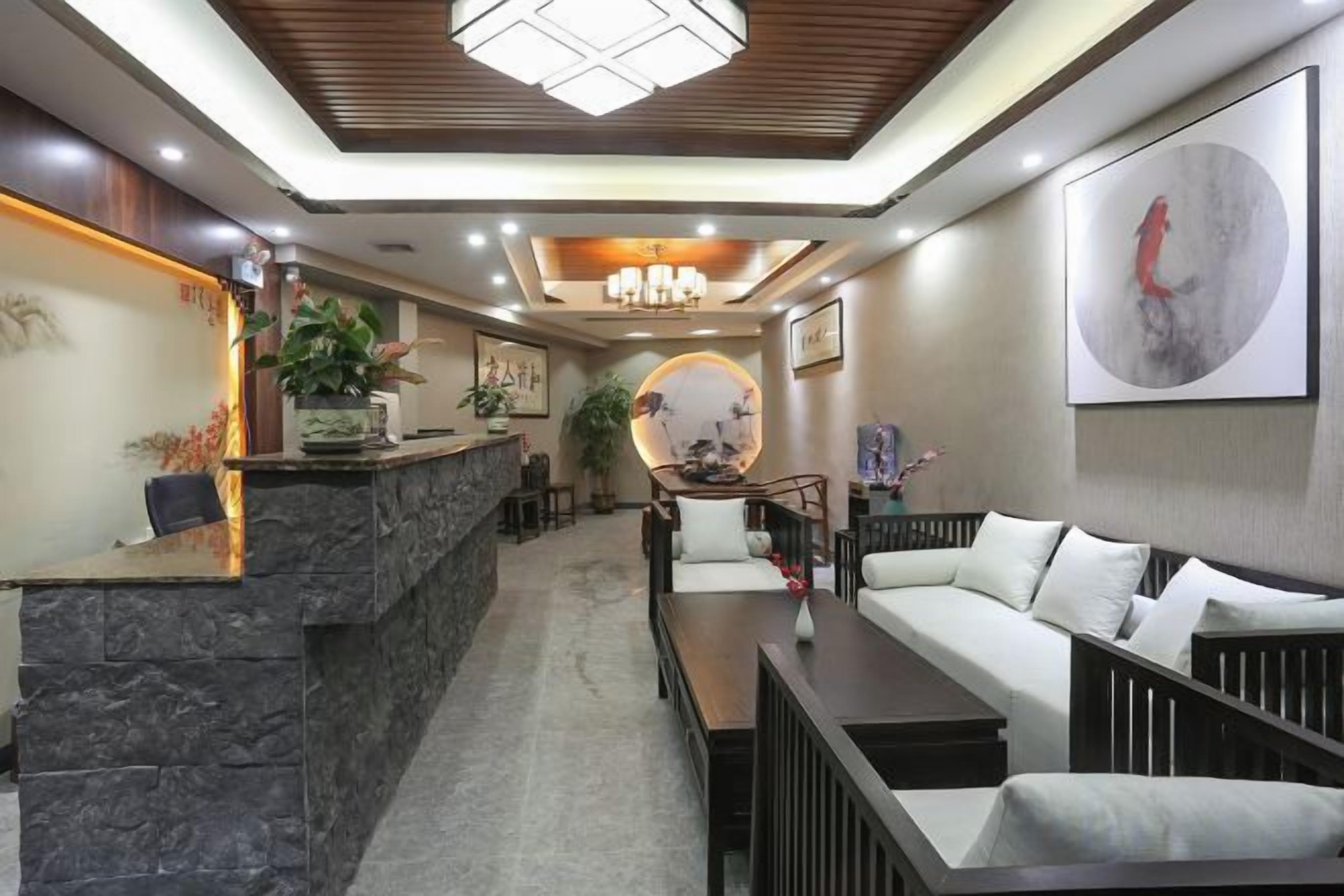 A reception area with a stone counter, a sofa, and a coffee table.