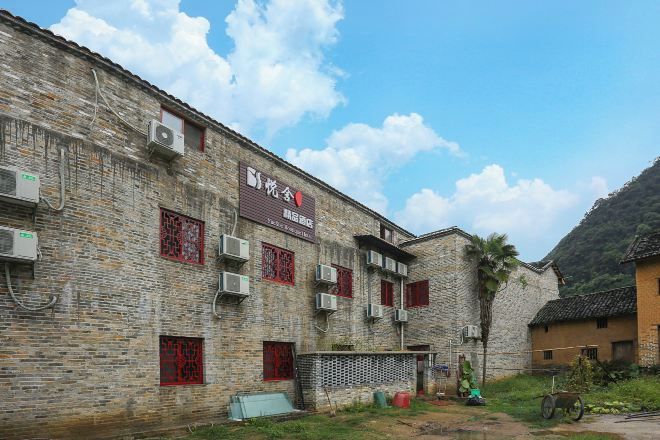 A traditional brick building with multiple windows and air conditioning units.