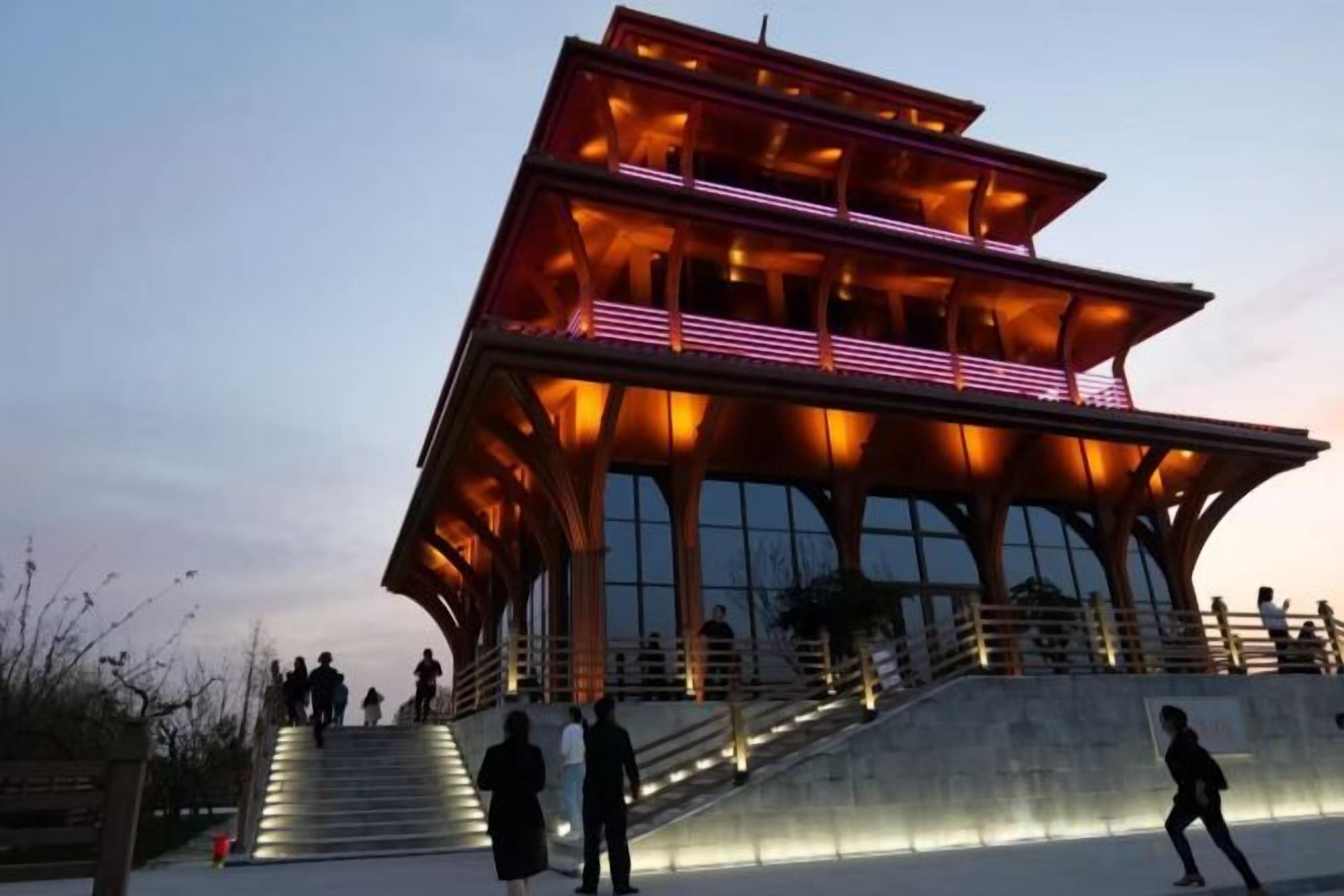 A modern building with a unique architectural design, featuring a prominent staircase leading to the entrance.