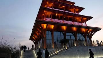 A modern building with a unique architectural design, featuring a prominent staircase leading to the entrance.