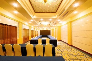 A conference room with a long table, yellow chairs, and a carpeted floor. - Bayin Guoleng Hotel (Korla)