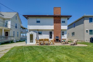 Enjoy outdoor dining or relaxation on the enclosed porch with a wooden table and chairs.