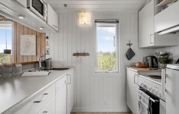 Fridge, stovetop, dishwasher, coffee/tea maker