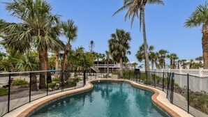 A swimming pool surrounded by palm trees and a white fence. - Doubloon: Beach, Private Pool and Boating....This 4 Bedroom home has it all!! (Placida)