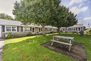 A row of single-story mobile homes with a grassy yard and a picnic table. - Cozy Mid-Cape Studio Steps to the Beach & Pool (Dennis Port)