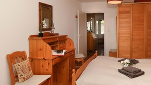 A bedroom with a wooden bed, a wooden dresser, a chair, a mirror, and a wardrobe. - Nice apartment for 4 people with WIFI, TV, balcony and panoramic view (Bluche)