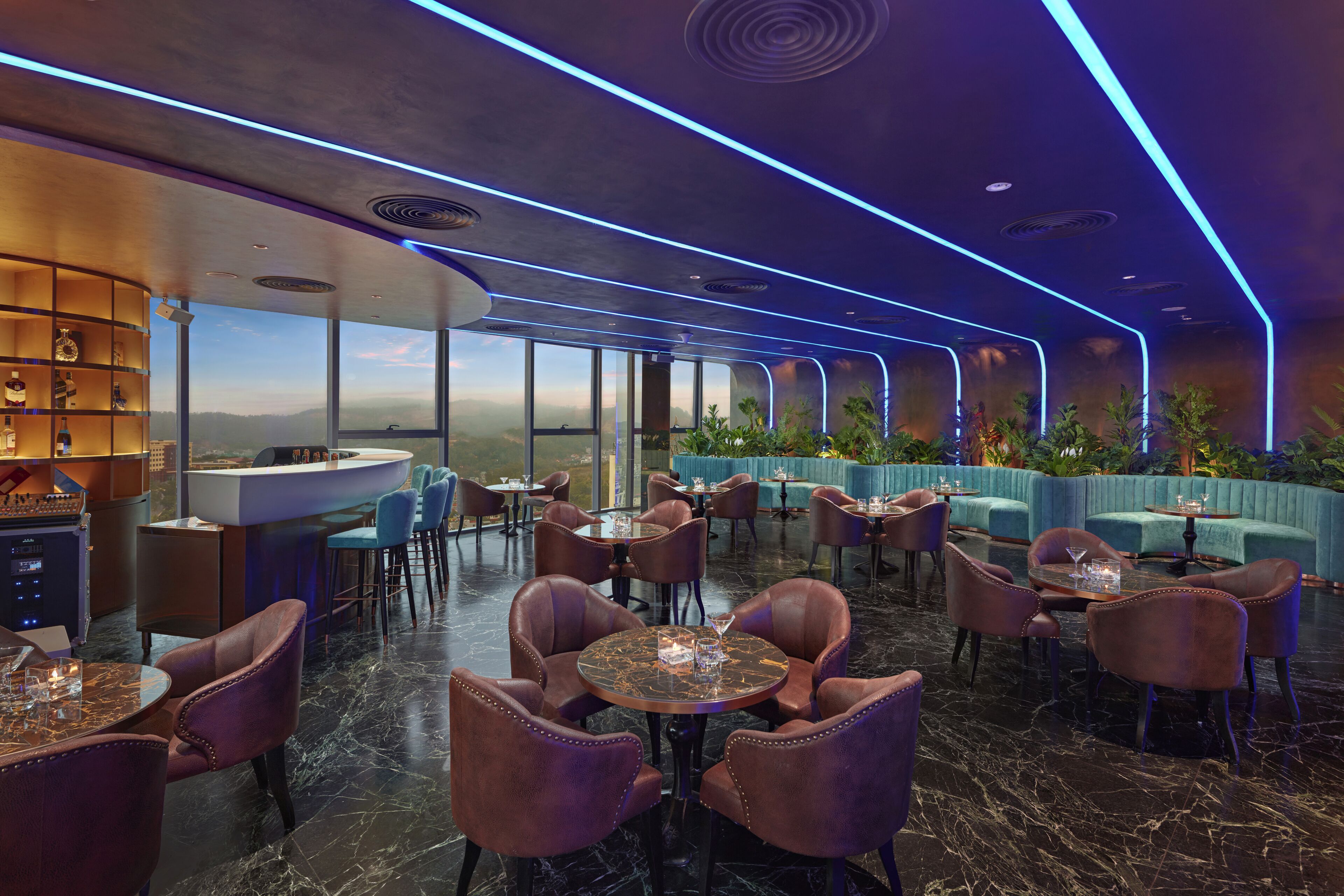 Un restaurante moderno con pisos de mármol, sillas de cuero y una zona de bar con estanterías.
