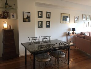 Cozy living space with a dining area, sofa, and wooden cabinet.