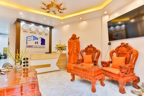 Basic Single Room | Living area | 43-inch TV with cable channels - Lighthouse & Rooftop (Hanoi)