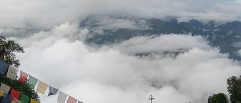 A mountainous landscape with clouds below the peaks.
