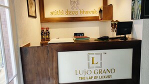 A reception desk with a sign reading "Atithi Devo Bhavah" and "Lujo Grand The Lap of Luxury". - Hotel Sapling Mussoorie - 500 Mtr from Picture Palace Mall Road (Dehradun)