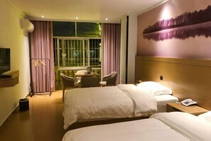 A hotel room with two beds, a desk with chairs, a large window with curtains, and a painting on the wall. - Xilinger Hotel ( Dongxing Hezhou Road) (Dongxing)