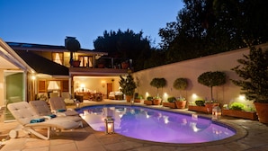 A swimming pool with lounge chairs and potted plants. - LeBonheur (Cape Town)