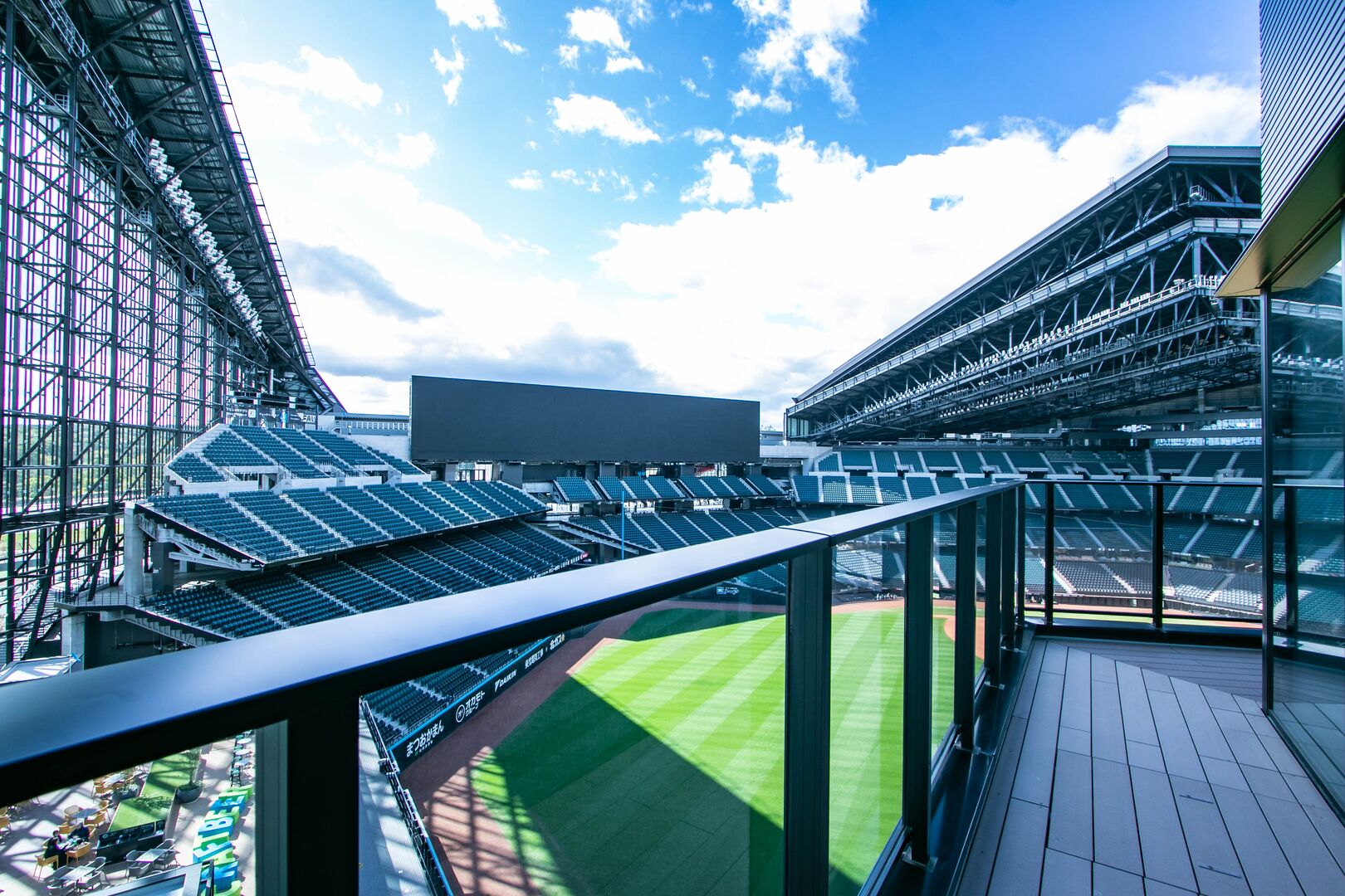 A stadium with tiered seating and a large open field.