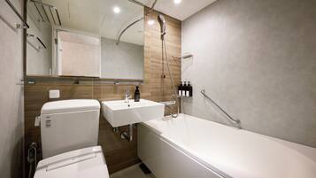 A modern bathroom with a bathtub, a toilet, and a sink.