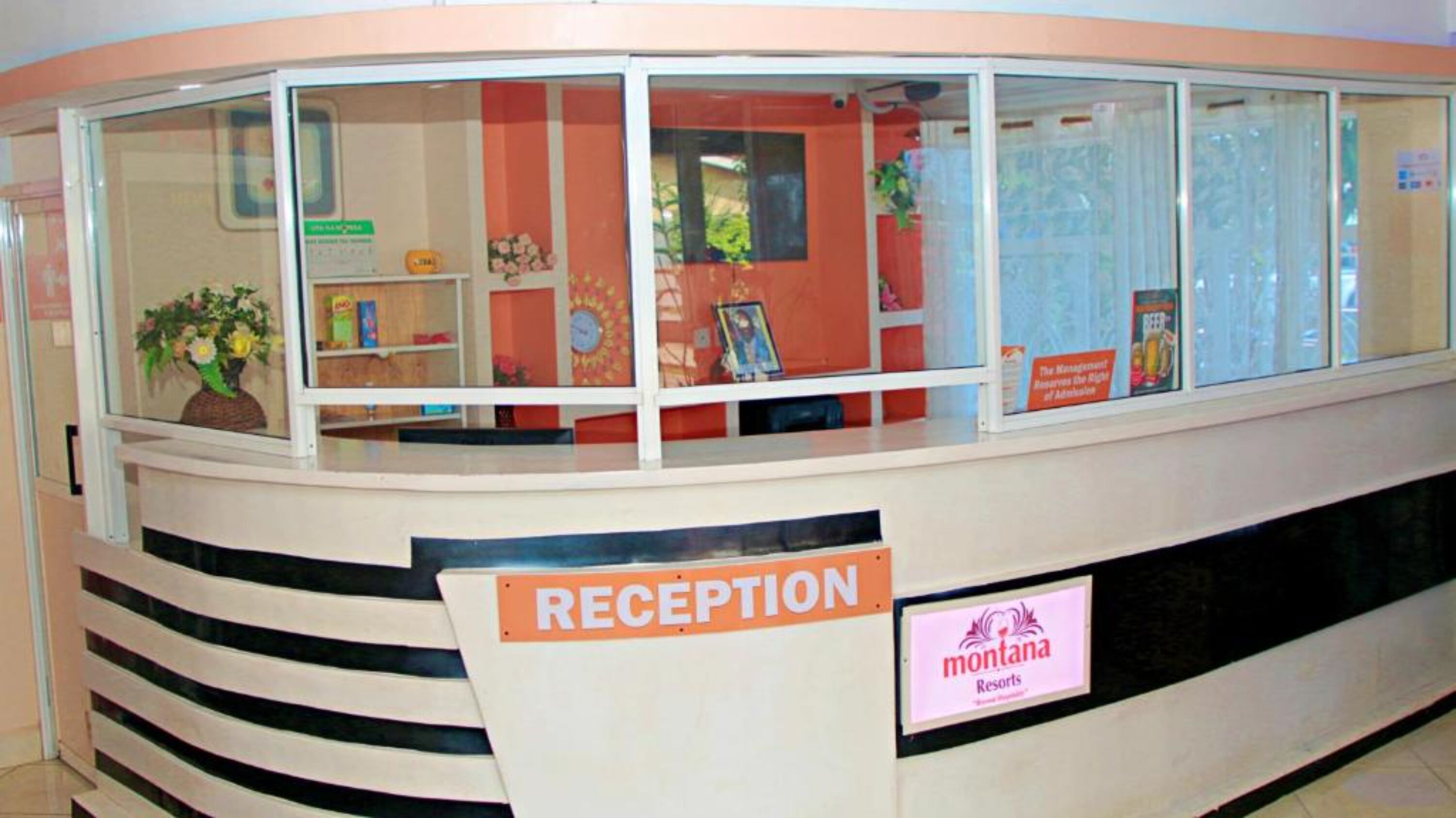 A reception area with a sign reading "RECEPTION" and "montana resorts".