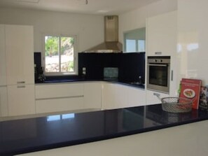 Fridge, stovetop, dishwasher, coffee/tea maker