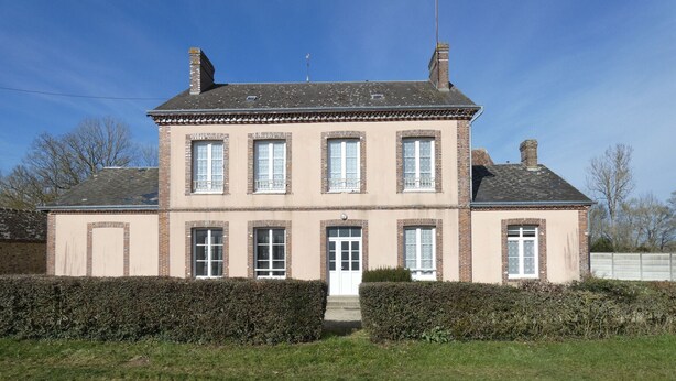 A two-story building with a symmetrical facade, multiple windows, and a central entrance.