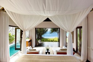 A bedroom with a large bed, a view of the ocean, and a pool. - The Ungasan Clifftop Resort (Pecatu)