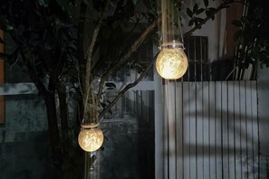 Two hanging spherical light fixtures with a textured surface, mounted on a vertical structure. - Dali Ancient Town No. 204 Ideal Youth Hostel (Dali City)