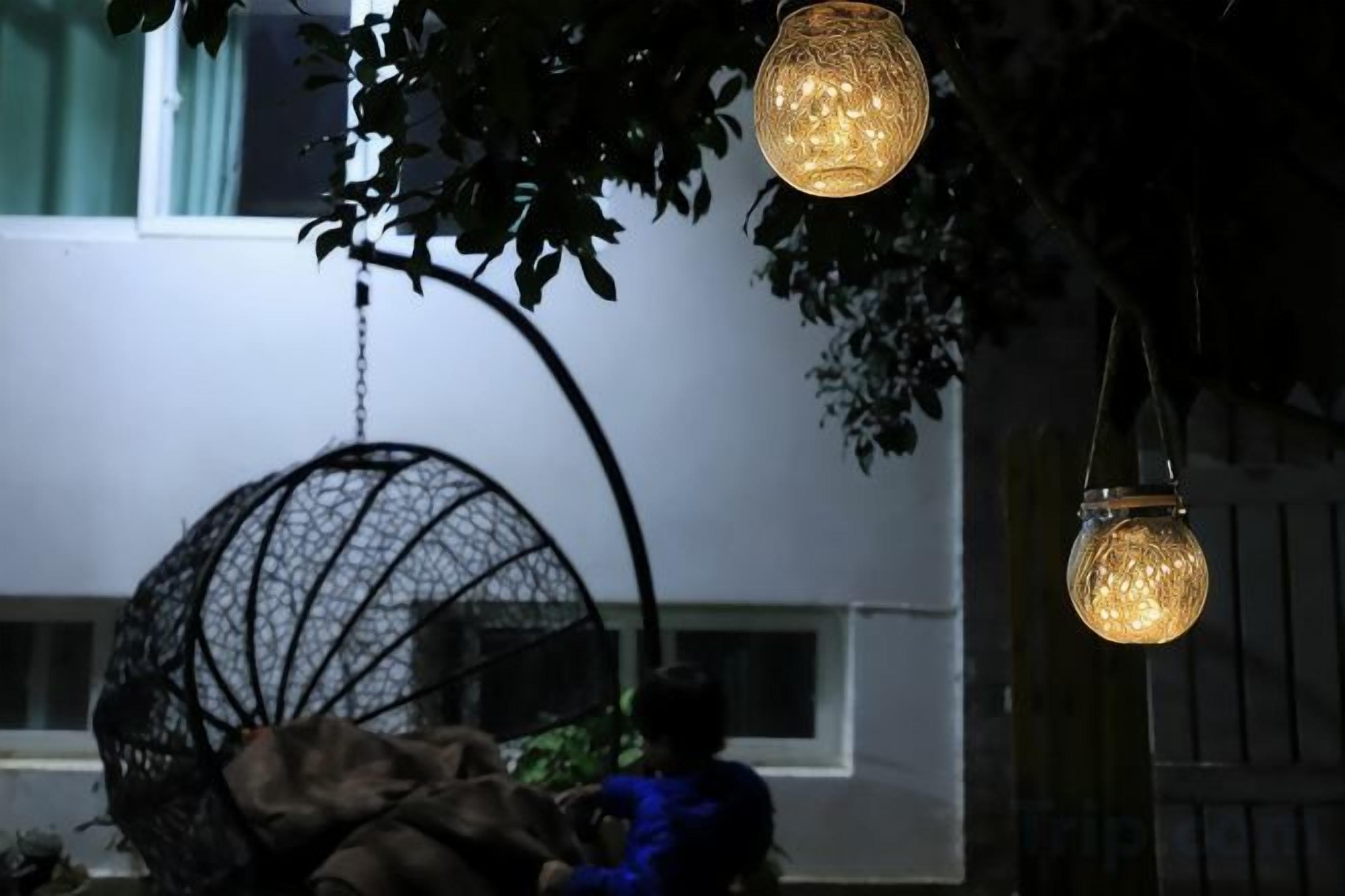 A hanging spherical light fixture and a spherical hanging chair.