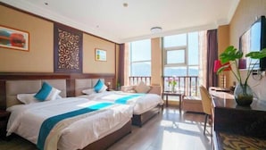 A hotel room with two beds, a balcony with a view, a desk, and a TV. - General Fenghua (Lijiang) Travel Center (Lijiang)
