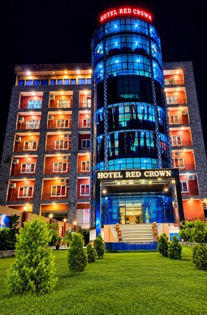A multi-story hotel with a prominent 'HOTEL RED CROWN' sign, featuring a modern design with glass and metal elements. - Hotel Red Crown Pvt Ltd-Bardibas (Bardibas)