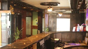 A reception desk with a computer, a plant, and a tiger statue. - Hotel Red Crown Pvt Ltd-Bardibas (Bardibas)