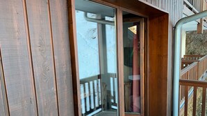 A wooden exterior with a sliding glass door leading to a balcony. - Duplex for 8 with WiFi, balcony and parking in Valloire (Valloire)