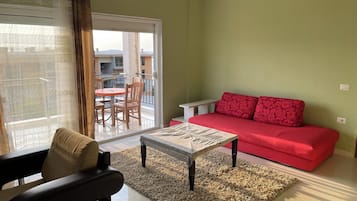 Panoramic Apartment, Sea View, Garden Area | Living area | 30-inch TV with cable channels