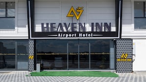 The exterior of the Heaven Inn Airport Hotel with a modern design, featuring a prominent logo and clear signage. - Heaven Inn Airport Hotel (Arnavutköy)