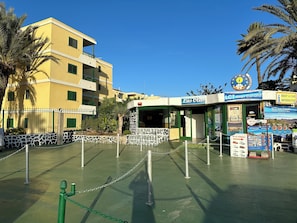 A building with a sign for 'Las Olas' and 'LCT Gran Canaria' indicating a partnership.