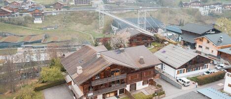 A traditional chalet-style building with a wooden exterior, a balcony, and a sloped roof.