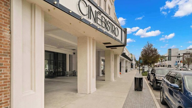 A Cinebistro with a modern facade, large windows, and a clear sky. - The Adaline #1 -  Luxury Hyde Park Apt Near Bayshore (Tampa)